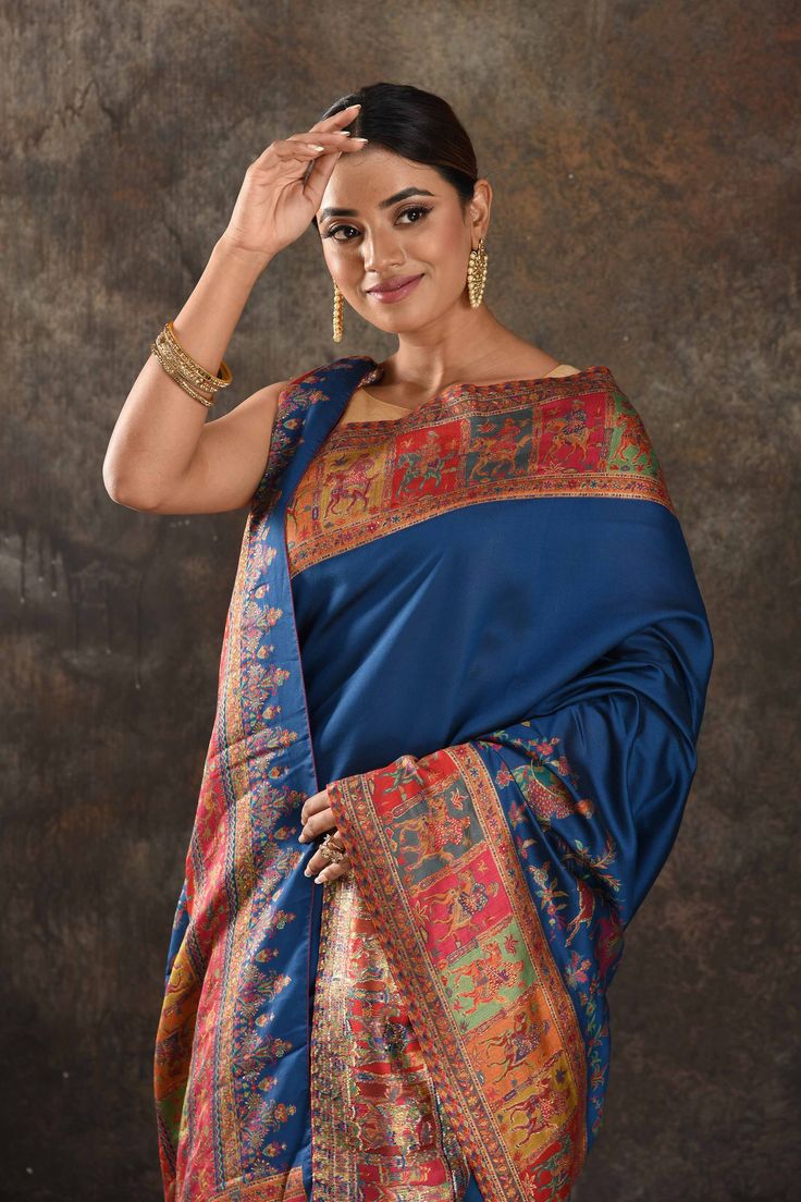 Exquisite blue Kani silk saree is one of a kind drape for a saree wardrobe! It comes with a matching blouse piece. Shop designer sarees in USA from Pure Elegance. Disclaimer: The shown stitched blouse on the model is for display purpose only. The saree comes with a matching blouse piece and finished with fall and piko. The actual product may vary slightly from the image. These are custom orders, hence expect slight variation in color, placement of the motif or buta. ESTIMATED DELIVERYBecause this is a custom order, it would take about 4 weeks from the date of purchase. RETURN POLICYThis product is a custom order and cannot be returned or exchanged. Blue Silk Anarkali Pre-draped Saree, Festive Blue Art Silk Pre-draped Saree, Bollywood Style Blue Pre-draped Saree For Eid, Designer Blue Dupatta For Navratri, Blue Raw Silk Pre-draped Saree For Festivals, Blue Pre-draped Saree With Unstitched Blouse For Festivals, Blue Silk Pre-draped Saree In Traditional Style, Festive Blue Tussar Silk Pre-draped Saree, Blue Pre-draped Saree With Zari Work For Festivals