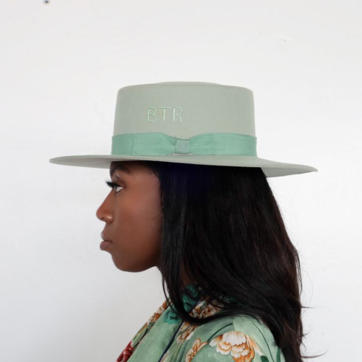 Turn heads & grab everyone’s attention in the Kayo Boater Hat in mint green. Highlighted in a calming mint green hue, it’s designed with an elongated brim, round top, and bow band for a dainty touch. Hand embroidered with BTR initials. 100% Australian Wool Adjustable inner band for sizing 4” Crown Height 3.25” Brim Multiple colors SHIPPING POLICY We process your order in 24-48 hours. Hats typically ship within 3-5 business days, or sooner. Expedited shipping options are available at checkout. We Fitted Top Hat With Flat Crown For Spring, Fitted Felt Hat With Flat Crown For Spring, Green Hat Bands For Kentucky Derby, Adjustable Green Fedora For Spring, Adjustable Green Flat Brim Fedora, Green Fedora For Kentucky Derby, Adjustable Wide Brim Green Felt Hat, Green Short Brim Fedora For Spring, Green Fedora With Curved Brim For Spring