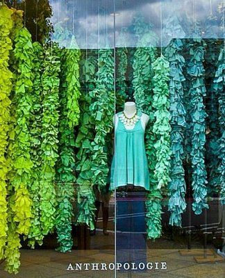 there is a mannequin standing in front of some green plants and trees with the words anthropologie on it