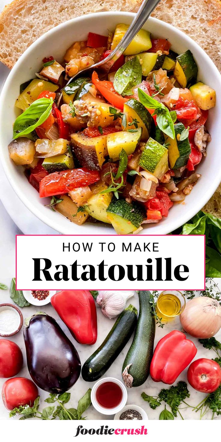 a white bowl filled with ratatoulie next to sliced bread and vegetables on a plate