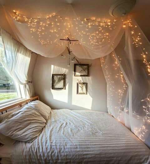 a bedroom with lights strung from the ceiling