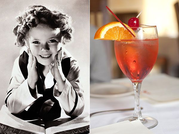 a woman sitting at a table next to an open book and a glass of wine