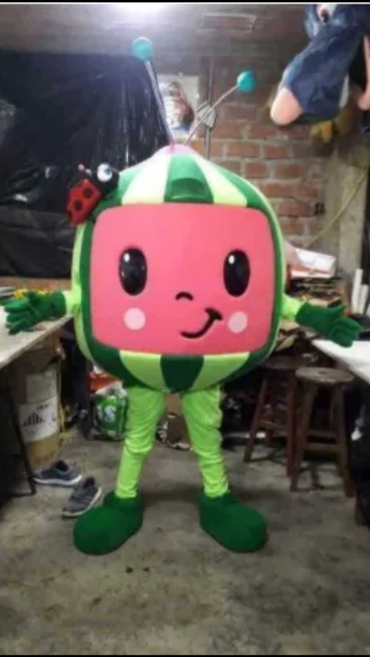 a person in a costume standing next to a table