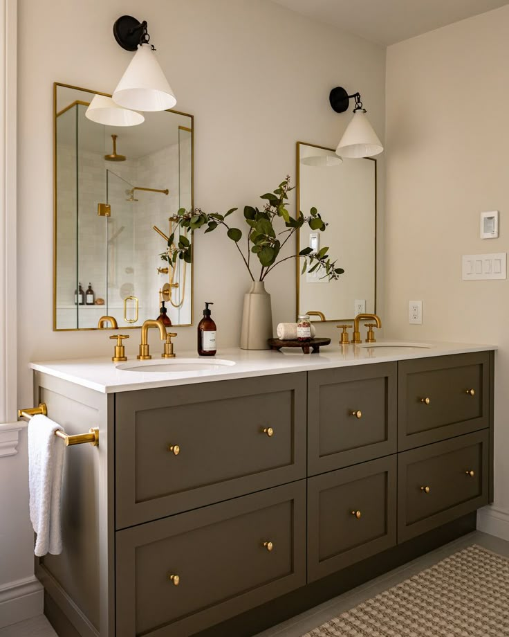 a bathroom with two sinks and mirrors on the wall