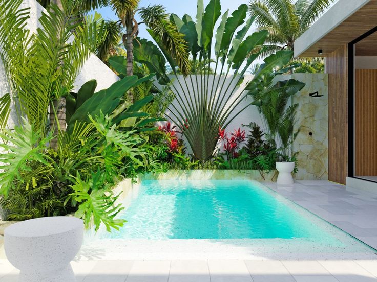 an outdoor swimming pool surrounded by palm trees and plants, with a white planter in the foreground