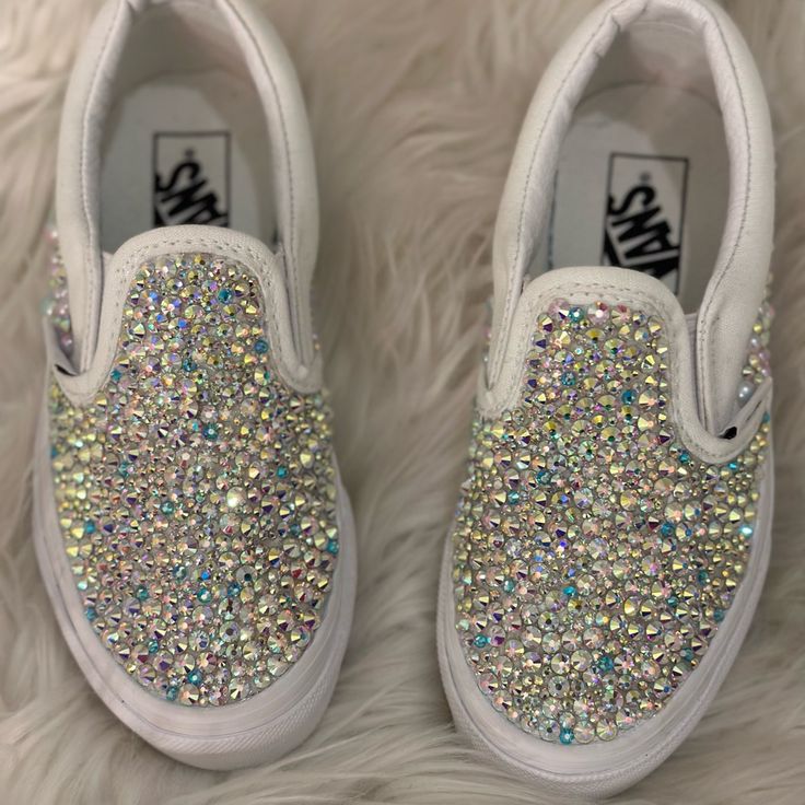 a pair of white shoes with colorful sequins on them