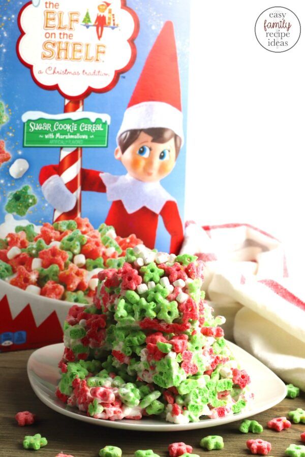 the elf in the shelf christmas tree is next to a box of cereal and some candy