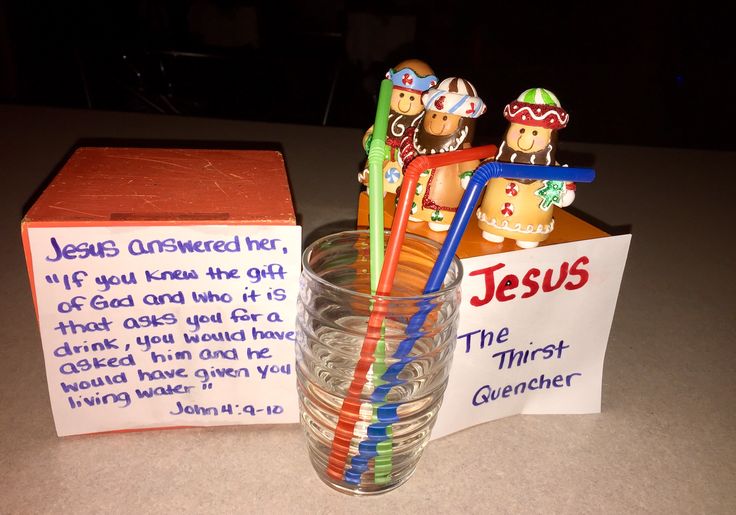 a glass filled with toothbrushes sitting next to a box and some paper on the table