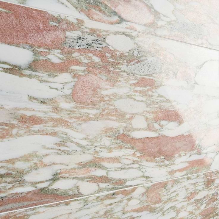 a bathroom with pink and white marble on the walls