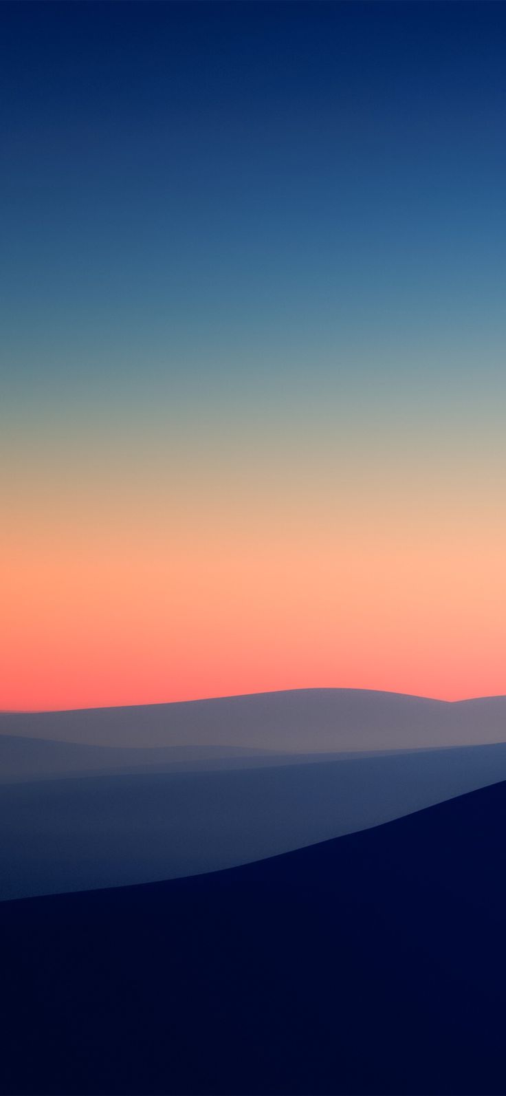 an airplane flying in the sky at sunset with mountains in the background and clouds below