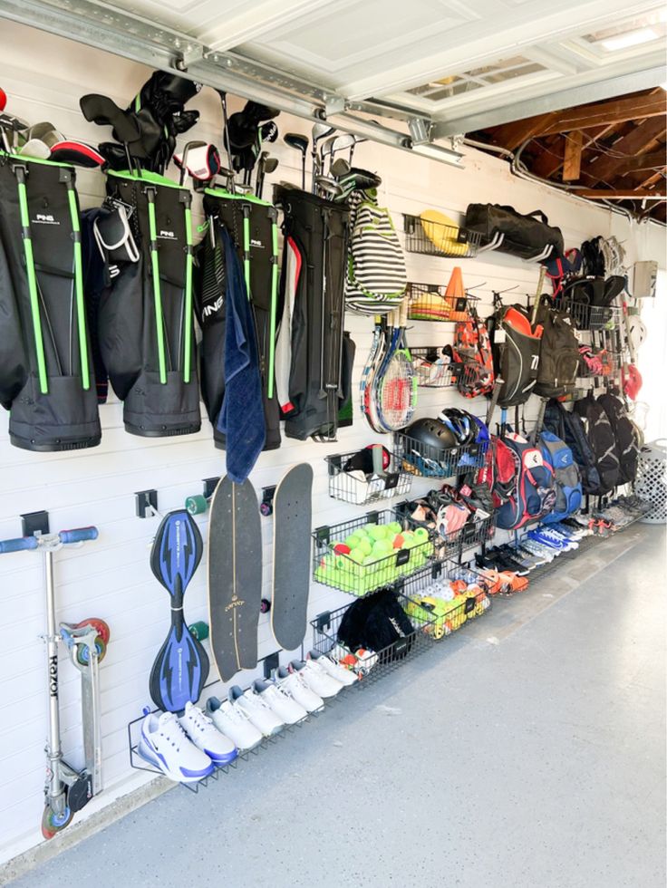 the inside of a garage with many surfboards and equipment hanging on the wall next to each other