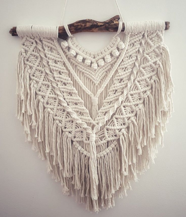 a white macrame hanging on a wall