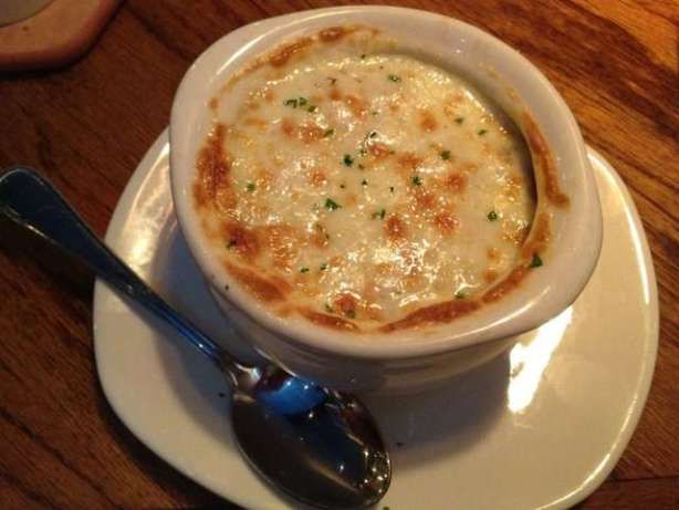 a bowl of soup on a plate with a spoon