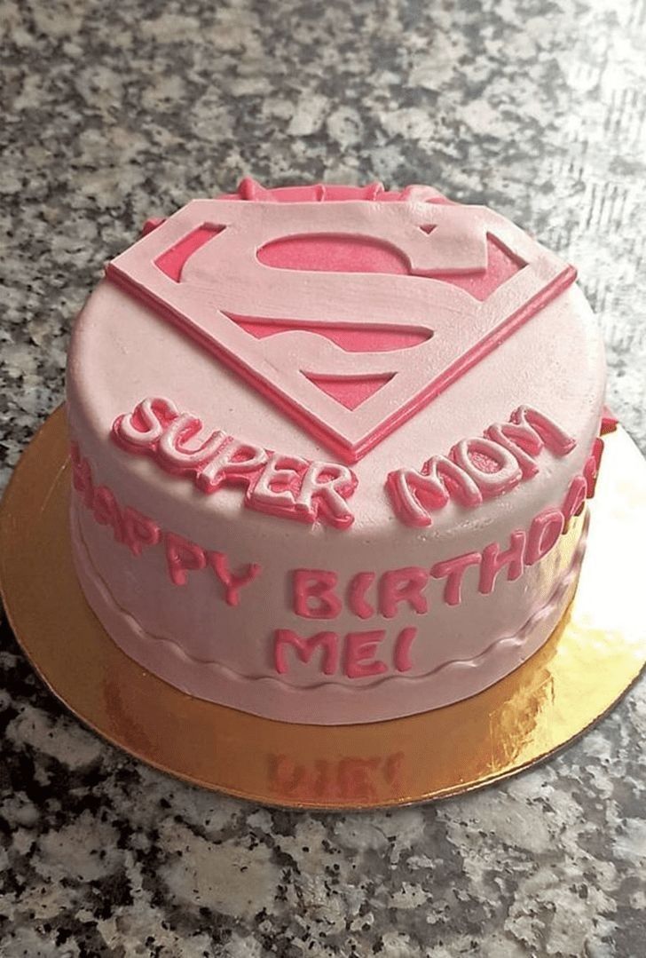 a birthday cake with pink frosting and a superman symbol on top that says happy birthday me