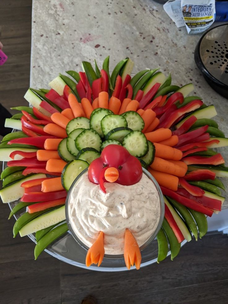 a platter with carrots, cucumbers and celery