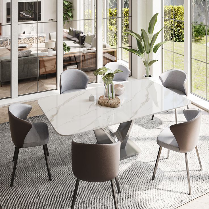 a dining room table with chairs and a potted plant in the middle of it