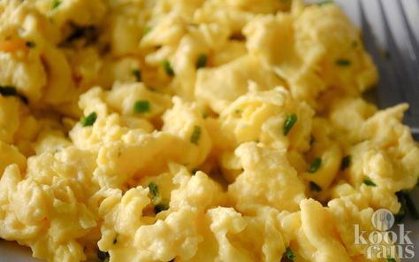 scrambled eggs on a plate with a fork