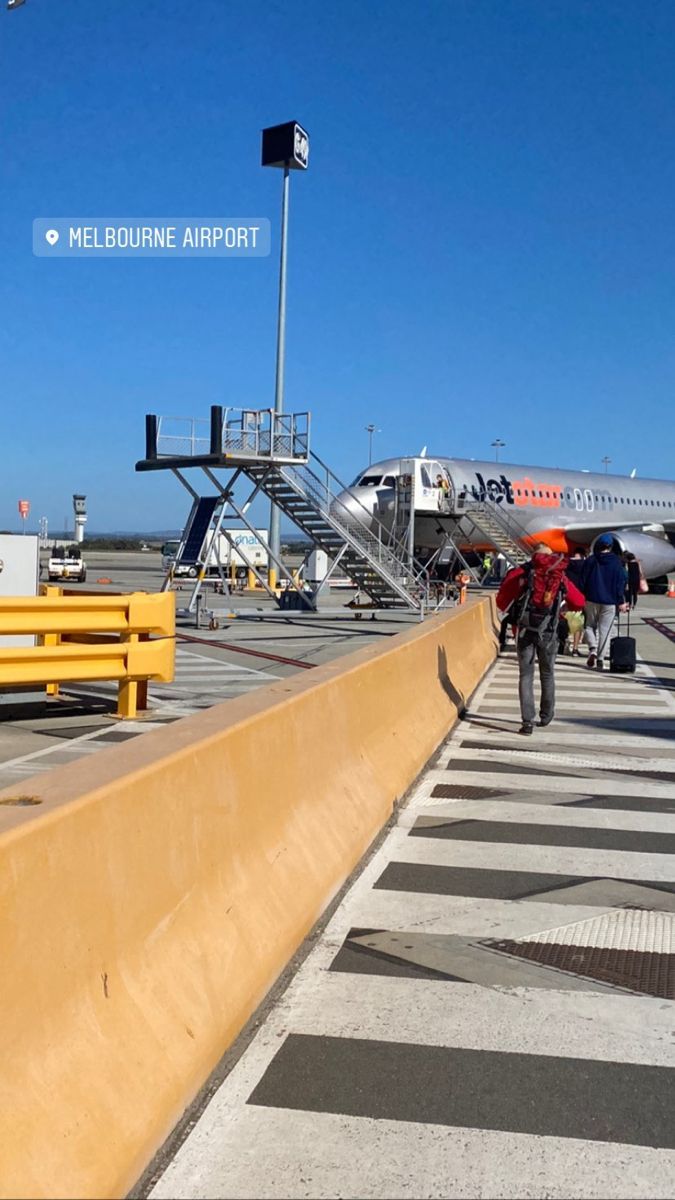 people walking towards an airplane on the tarmac