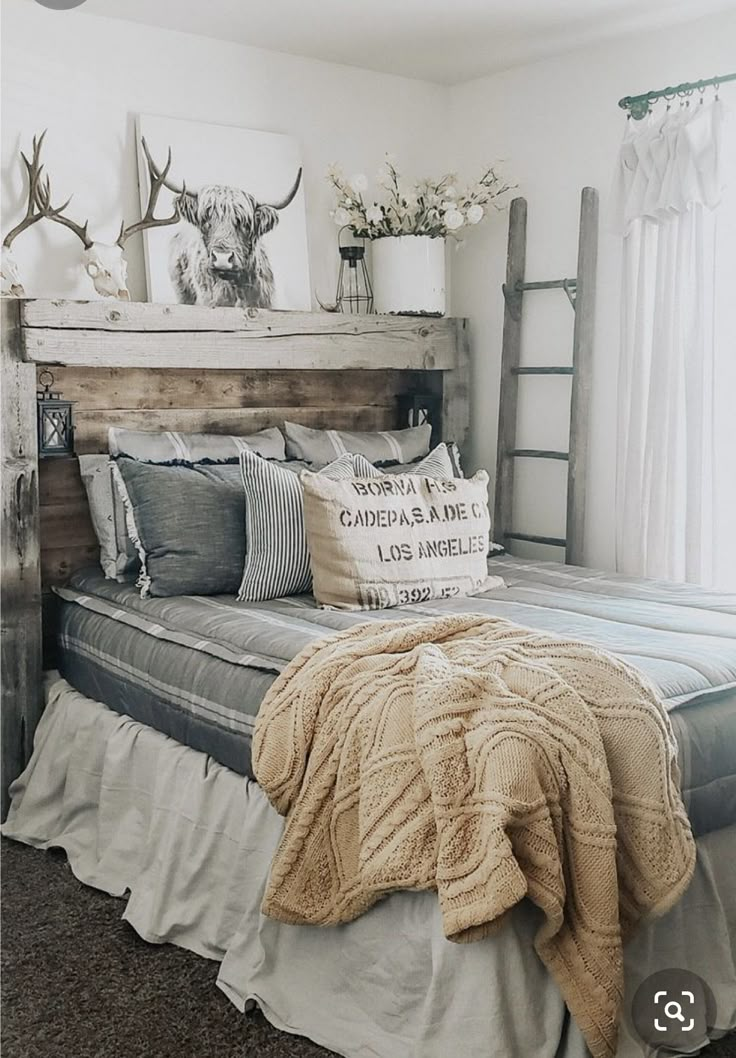 a bed sitting in a bedroom next to a tall wooden headboard with antlers on it