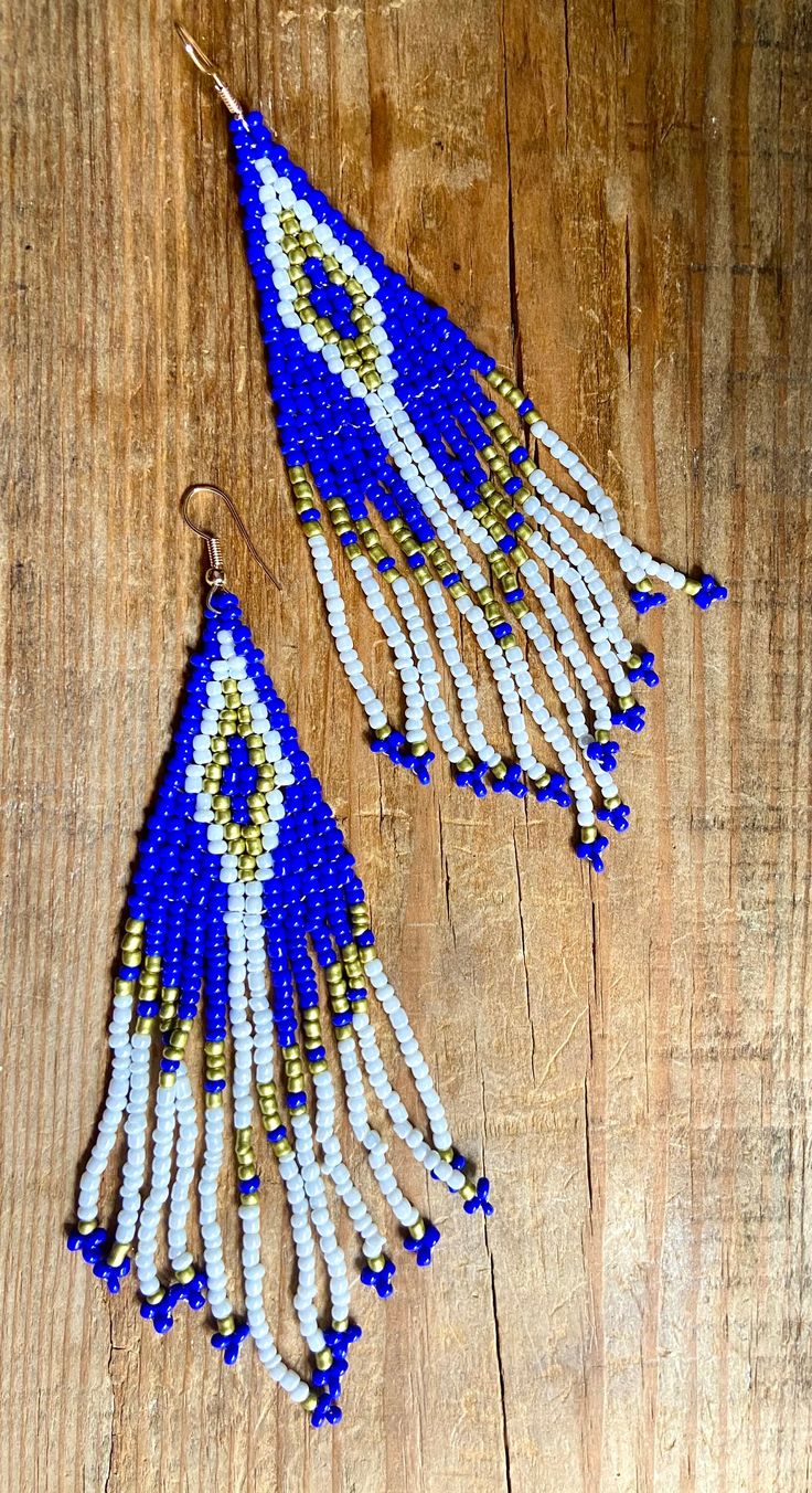 Beautiful blue white & gold beaded boho dangles with beaded fringe.Recycled.  surgical steel ear hooks. 4.5 cm long. Blue Fringe Dangle Chandelier Earrings, Blue Tassel Earrings With Round Beads, Blue Fringed Beaded Drop Earrings, Blue Fringe Beaded Drop Earrings, Blue Beaded Fringe Earrings For Festival, Bohemian Blue Earrings With Beaded Fringe, Blue Bohemian Beaded Fringe Earrings, Bohemian Blue Beaded Fringe Earrings, Blue Fringed Beaded Earrings For Festival