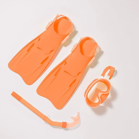 an orange plastic toy set on a white surface next to it's contents and tools