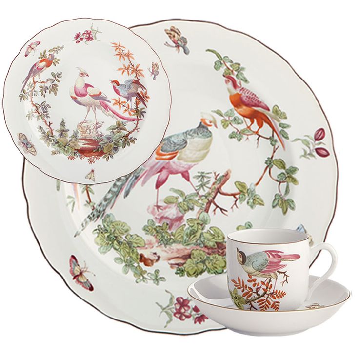 an image of a set of dinnerware with birds and flowers on the plate, cup and saucer