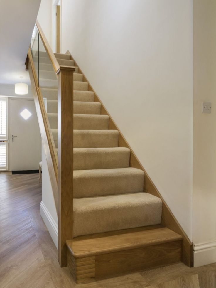 the stairs are made of wood and beige carpet