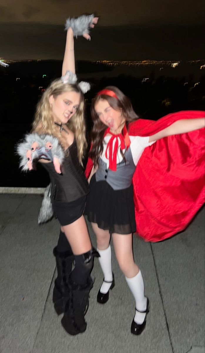 two women dressed in costumes posing for the camera