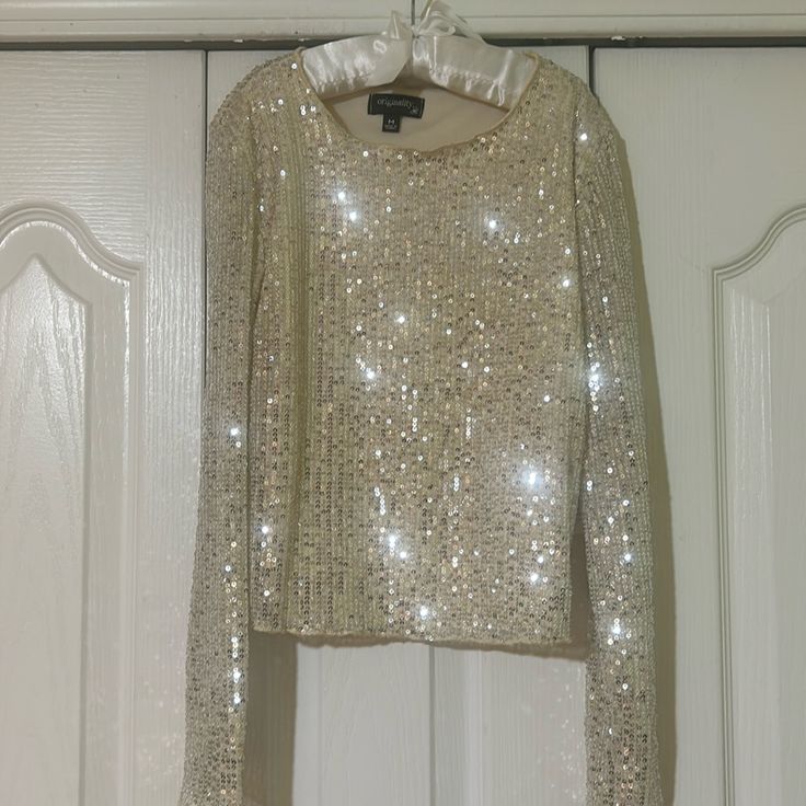 Big Girl Size M. Cream Colored With Silver Sequins Metallic Shiny Top For Party Season, Festive Glitter Tops For Party Season, Metallic Shimmer Tops For Holiday, Metallic Shimmer Tops For Holidays, Metallic Shimmer Top For Holiday, Metallic Long Sleeve Tops For Party Season, Shiny Tops For Night Out And Holiday, Sparkling Long Sleeve Tops For Party Season, Glamorous Shimmer Top For Holidays