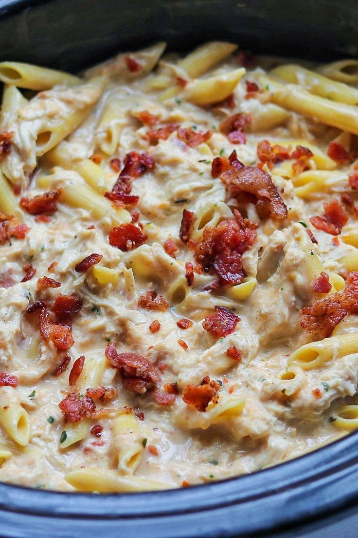 a close up of a pasta dish in a crock pot with meat and cheese