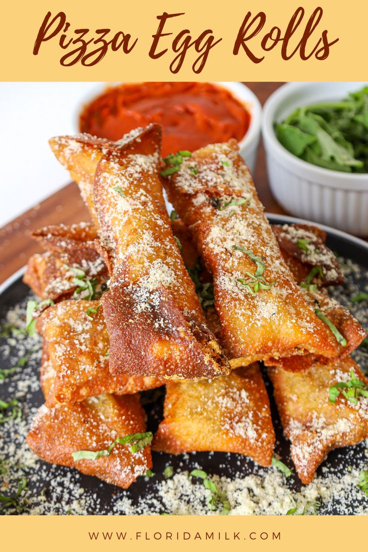 pizza egg rolls on a plate with sauce and lettuce in small bowls behind them