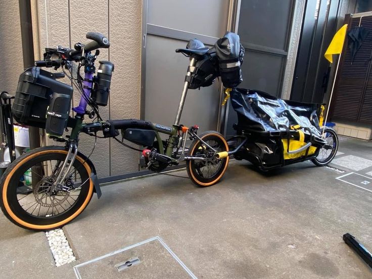 two bikes parked next to each other in front of a building