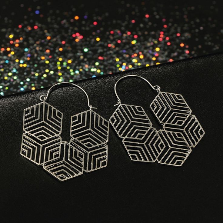 We're in love with geometrics and this pair says it all. Modern and totally on-trend. Gold or silver plated zinc casting. Post back. - Care Instructions: Avoid contact with water, lotion, and perfume. Clean gently with a polishing cloth. Product Specifications: - Elegant and timeless design - Hypoallergenic and safe for sensitive skin - Adds a touch of luxury to any outfit Modern Silver Hoop Earrings For Party, Modern Silver Alloy Earrings, Modern Nickel Free Jewelry For Party, Modern Nickel-free Jewelry For Party, Silver Retro Jewelry For Party, Retro Silver Jewelry For Party, Hypoallergenic Metal Jewelry For Parties, Geometric Metal Hoop Earrings As Gift, Silver Alloy Hoop Earrings As Gift