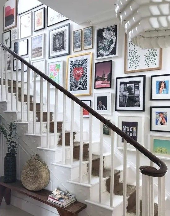 there is a staircase with pictures on the wall