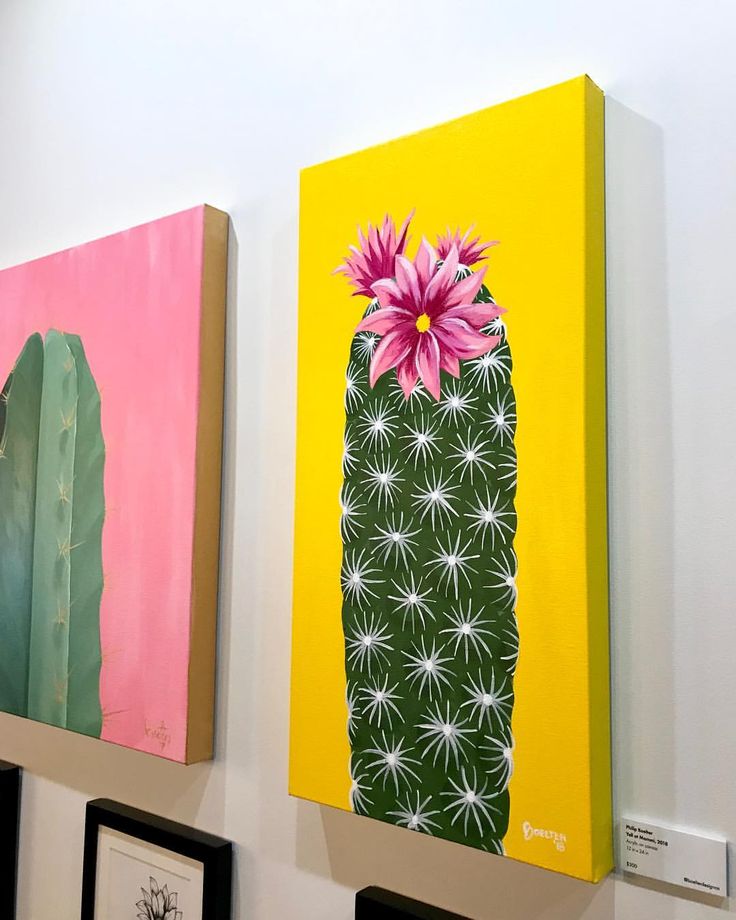 three paintings are hanging on the wall next to each other, one has a pink flower