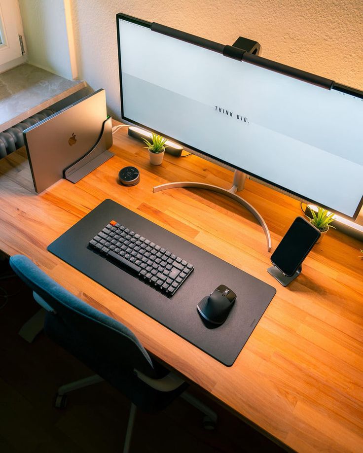 a computer desk with a keyboard and mouse