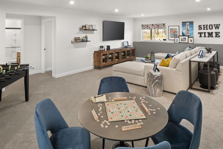 a living room filled with furniture and a game table