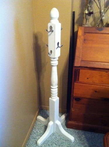 a tall white wooden pole next to a dresser