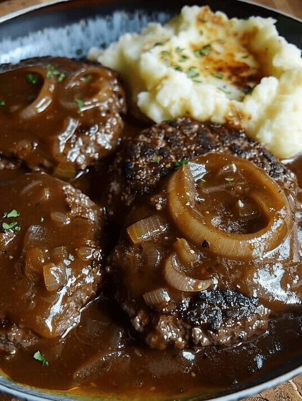 a close up of a plate of food with meat and gravy on it