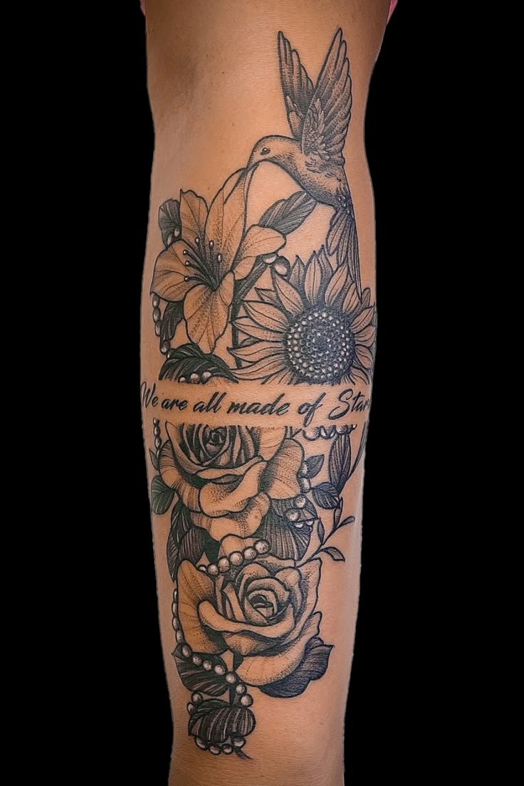 a woman's leg with flowers and birds on it