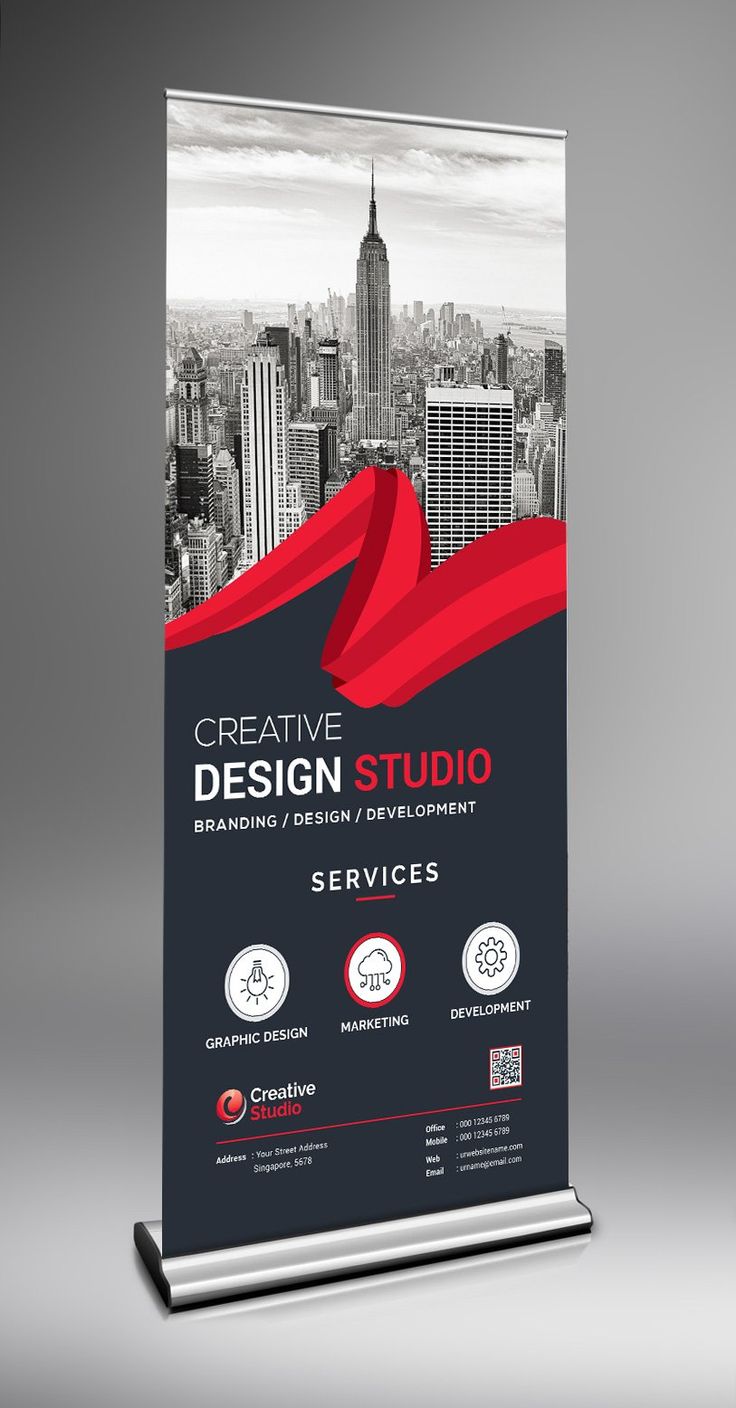 a roll up banner with the words creative design studio in red and black on it