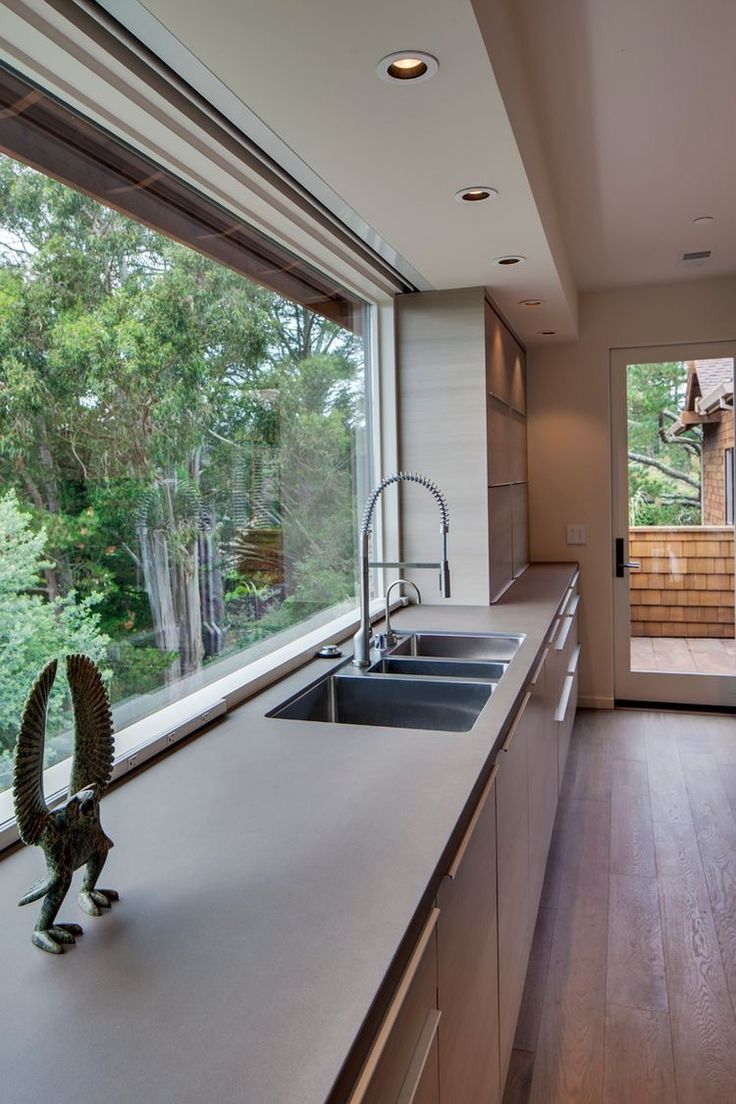 a kitchen with a large window and sink