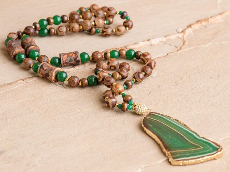 Tibetan agate, green agate, gold hematite and brass chain with large green agate slab. Bohemian style necklace is approximately 32". Looks great with the Freeform Green Recycled Brass Cuff, which is sold separately. Every item sold plants a tree through our partnership with One Tree Planted. Luxury Agate Beaded Necklace With Stones, Bohemian Malachite Necklaces For Healing, Green Bohemian Hand Wrapped Necklace, Bohemian Green Hand Wrapped Necklace, Green Agate Hand-wrapped Necklaces, Green Agate Hand Wrapped Necklaces, Green Hand Wrapped Agate Necklaces, Bohemian Green Agate Necklaces, Bohemian Green Onyx Necklaces With Natural Stones