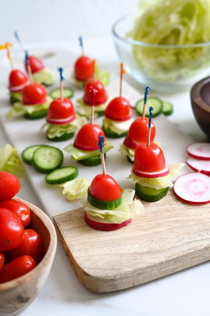 small appetizers with cucumbers, tomatoes and black olives on a platter