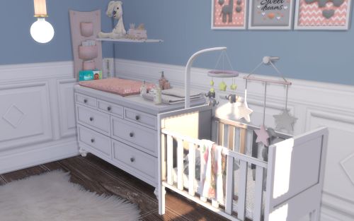 a baby's room with blue walls, white furniture and pictures on the wall