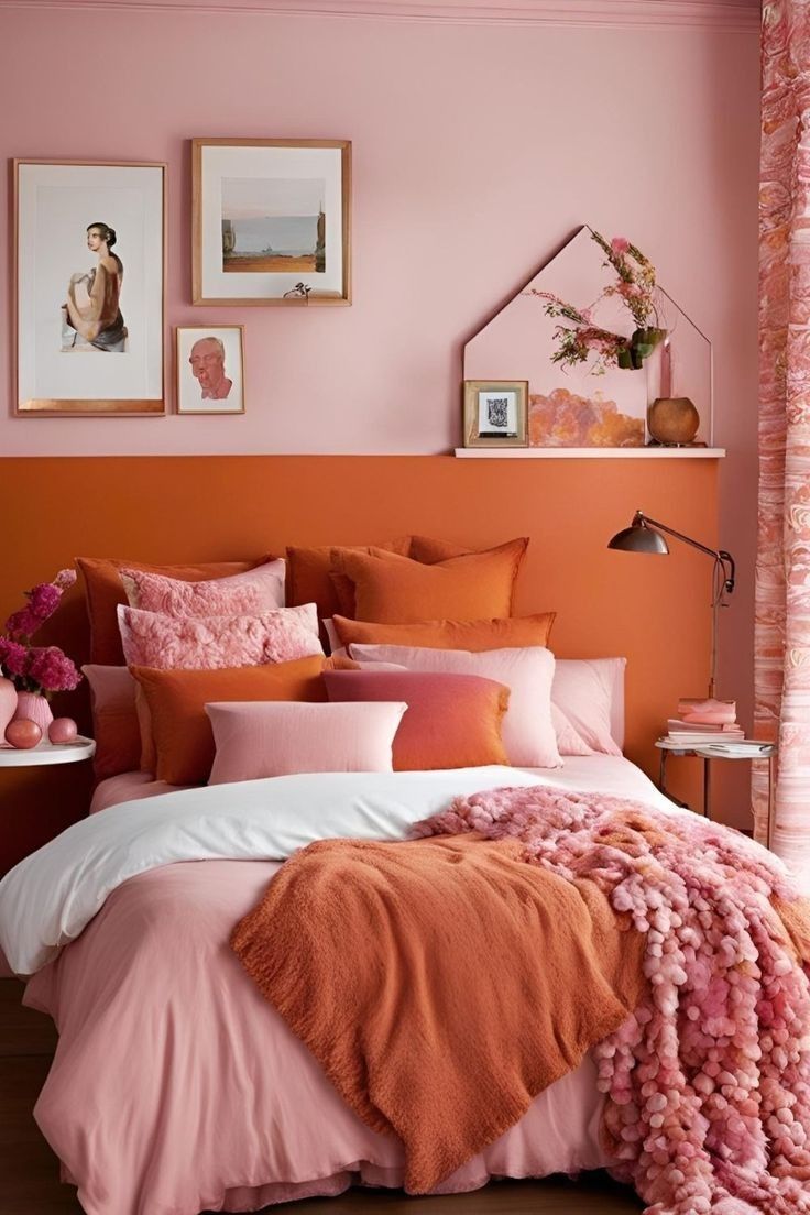 an orange and pink bedroom with pictures on the wall, bed linens and pillows