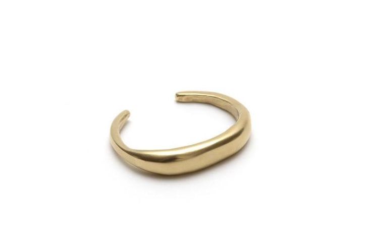 The Abrazo cuff lives up to its namesake. This piece gently hugs your wrist while maintaining a strong design that adds a bold, minimalist look to your everyday style! The cuff is originally hand carved in wax and then cast locally in solid brass or solid sterling silver. We clean and shape the cast piece by hand and t Gold Sterling Silver Cuff Bracelet, Adjustable 14k Gold Cuff Bracelet With Polished Finish, Classic Brass Bangle Cuff Bracelet, Gold Sterling Silver Cuff Jewelry, Minimalist Brass Bracelets, Minimalist Gold Cuff Bracelet In Sterling Silver, Minimalist Brass Bracelets Tarnish Resistant, Minimalist Tarnish-resistant Brass Bracelets, Metal Cuff Jewelry For Everyday