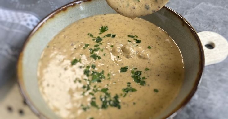 a bowl filled with soup sitting on top of a table