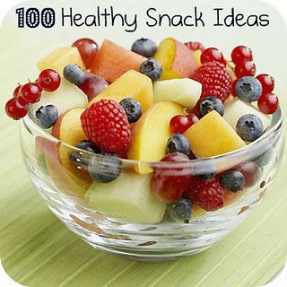 a glass bowl filled with fruit on top of a table