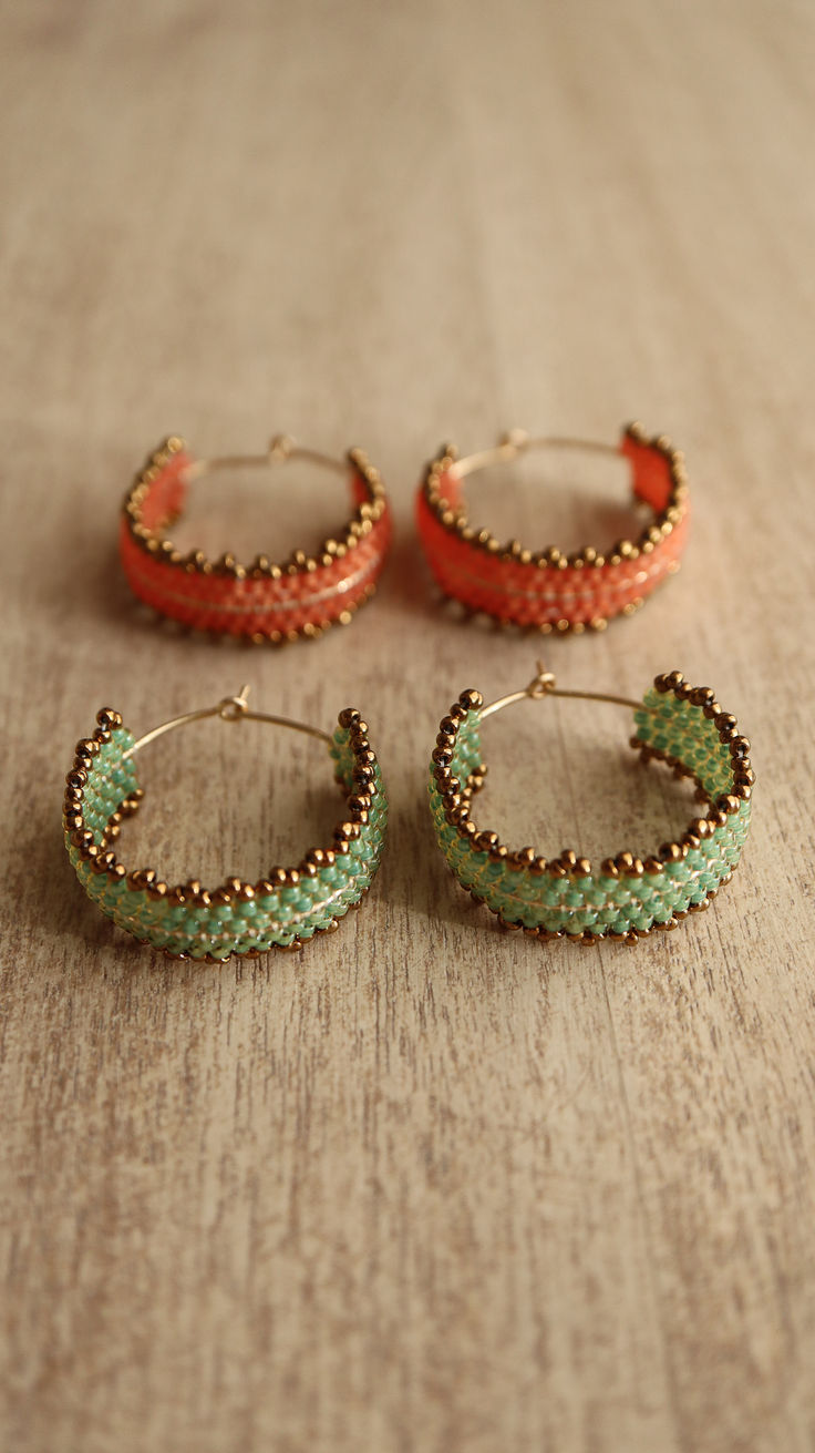 three pairs of beaded hoop earrings on a table